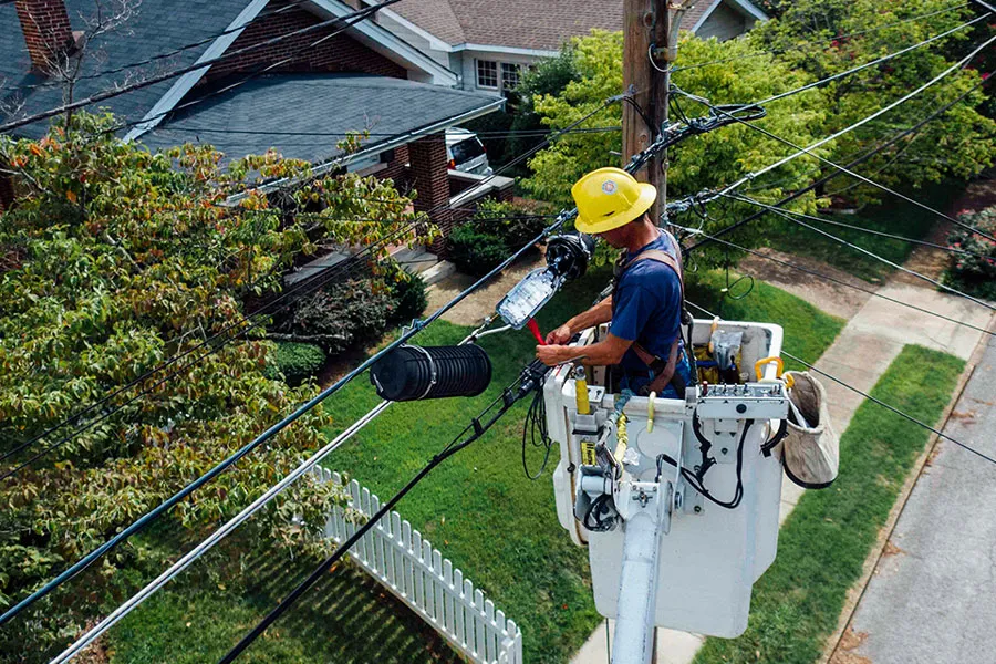 Lineman working on overhead electrical wires from a bucket truck